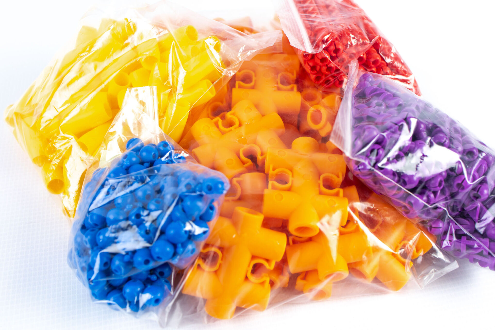 close up of colorful plastic pieces in clear plastic bags